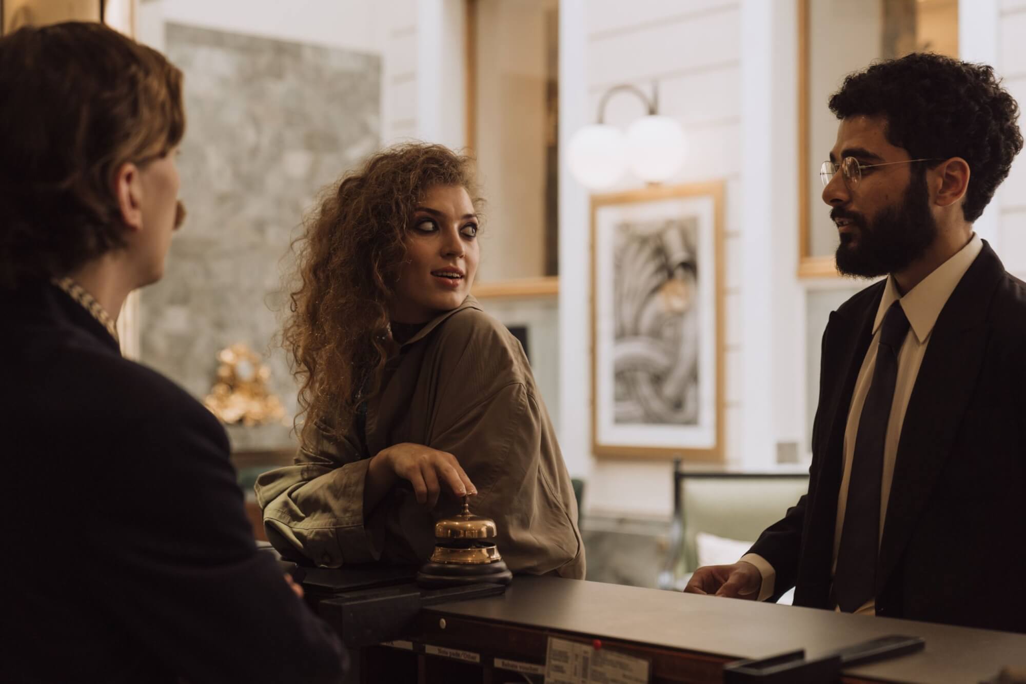 Customers speaking to staff at a hotel about the best road trip plan